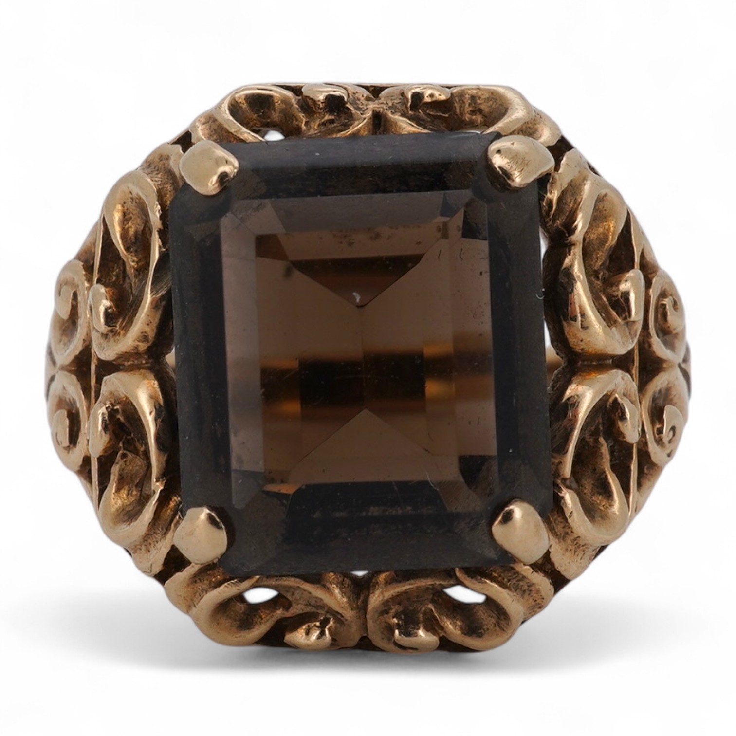 A smoky quartz dress ring, set with a step-cut smoky quartz, to a scrolled mount, size O, stamped PPLd 9CT, numbered, gross weight 6 grams